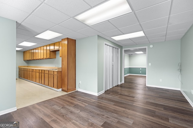 spare room with hardwood / wood-style flooring and a paneled ceiling