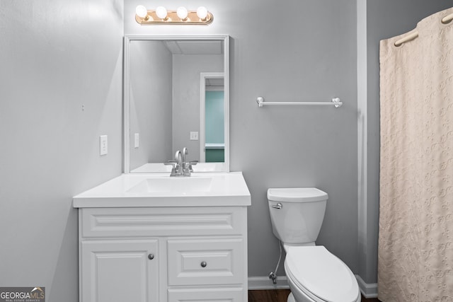 bathroom featuring vanity and toilet