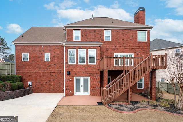 back of house with french doors, a deck, and a patio area