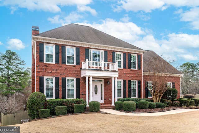 colonial home featuring a balcony