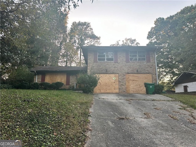 view of property featuring a garage and a front yard