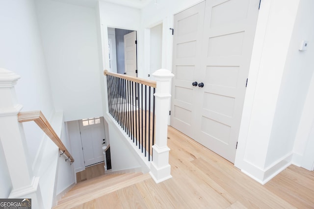 stairway with hardwood / wood-style floors