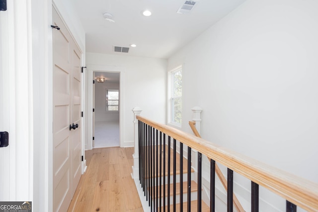 hall with light hardwood / wood-style floors