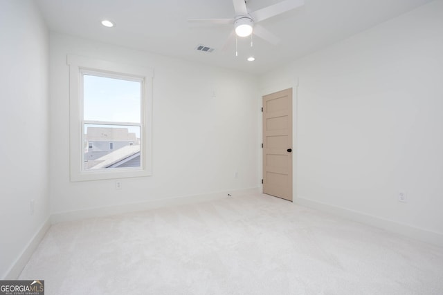 carpeted spare room with ceiling fan