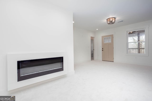 view of carpeted foyer entrance