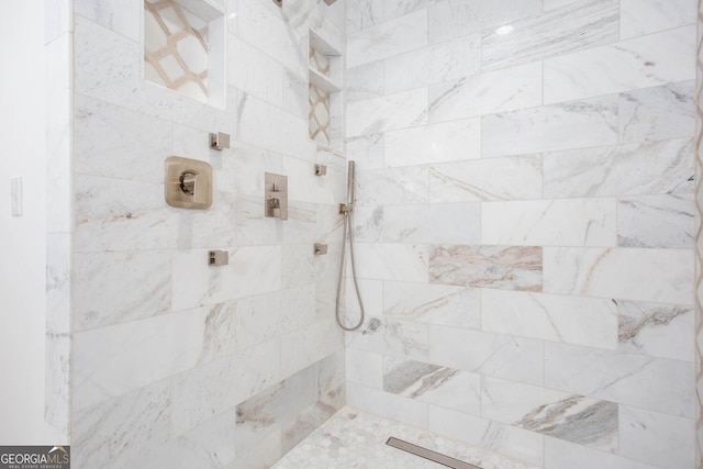 bathroom with tiled shower