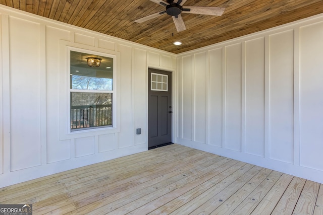 view of exterior entry featuring ceiling fan