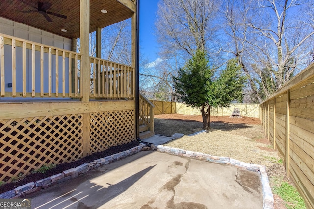 view of yard featuring a patio area, ceiling fan, and a deck