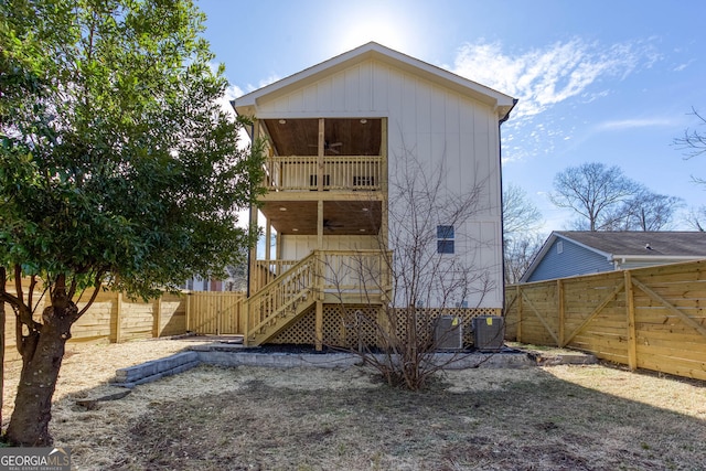 rear view of property with cooling unit, ceiling fan, and a balcony