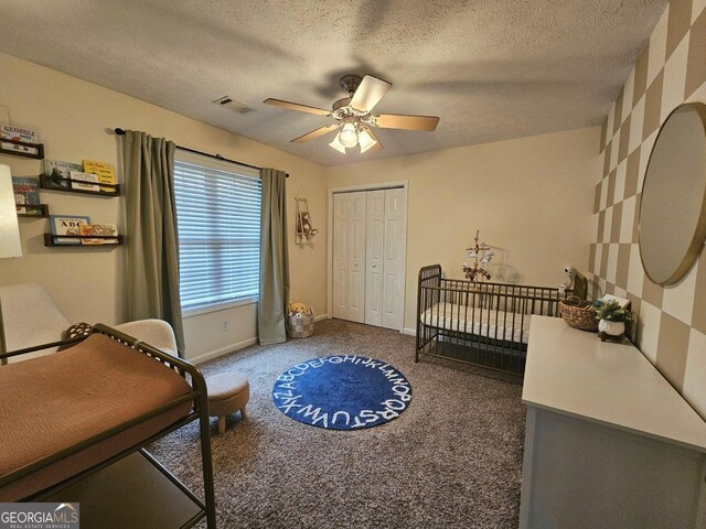 bathroom featuring tile patterned flooring, vanity, a textured ceiling, and toilet