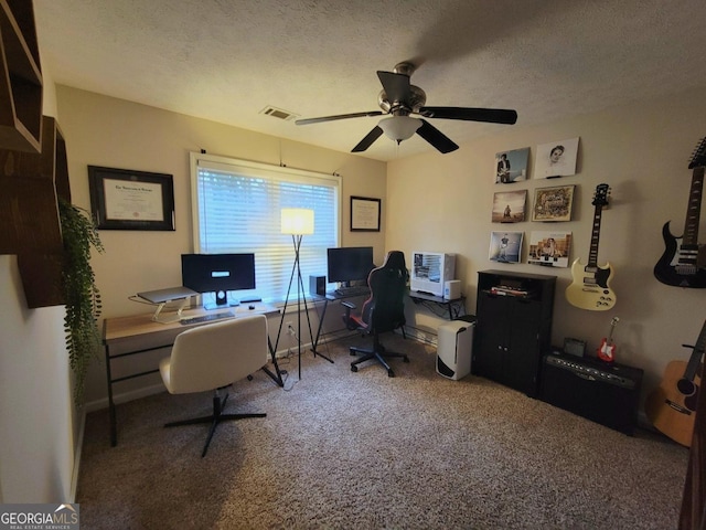 home office with ceiling fan, carpet flooring, and a textured ceiling