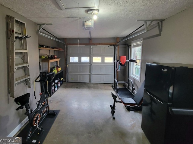 garage with a garage door opener and black fridge