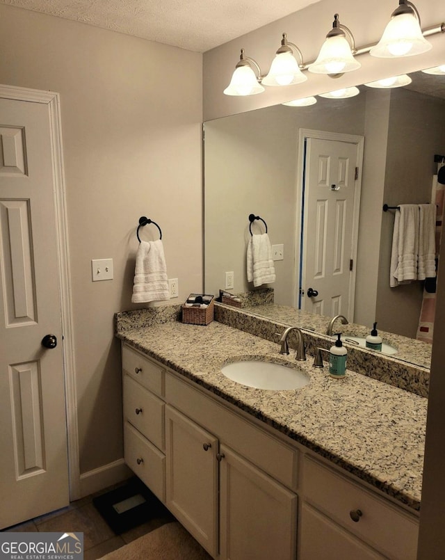 bathroom featuring vanity and a textured ceiling