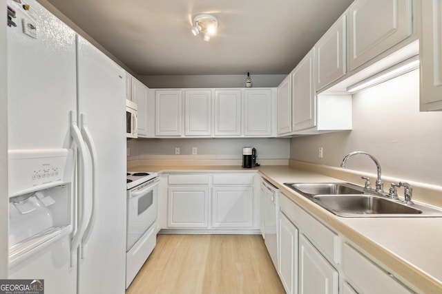 kitchen with white cabinetry, sink, white appliances, and light wood-type flooring