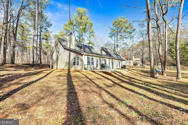 rear view of house with a yard