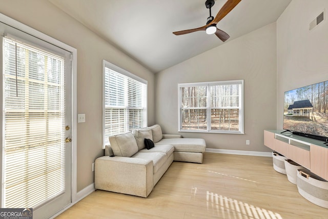 living room with vaulted ceiling, light hardwood / wood-style floors, and ceiling fan