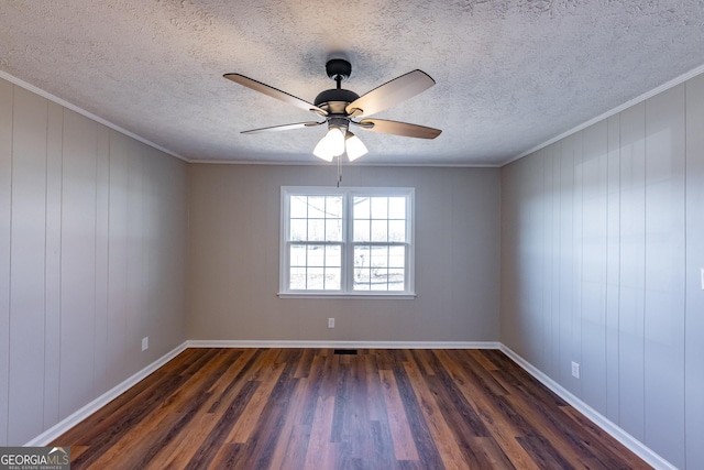 empty room featuring ornamental molding, dark hardwood / wood-style floors, and a textured ceiling