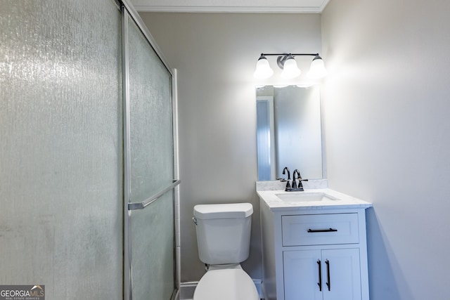 bathroom with vanity, a shower with door, and toilet