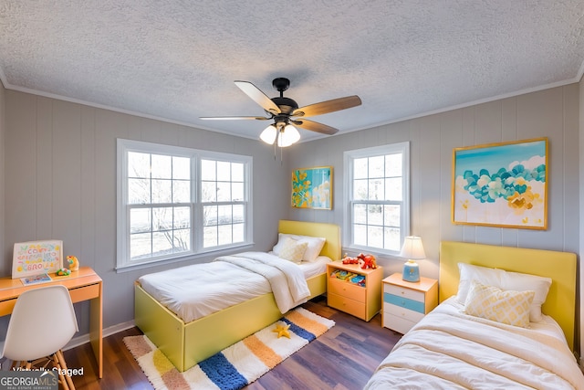 bedroom featuring ornamental molding, dark hardwood / wood-style floors, and a textured ceiling