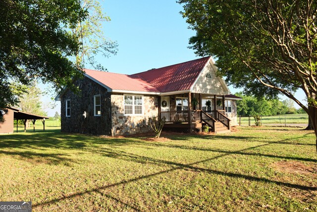 243 College St, Yatesville, GA 31097 - rear view of house with a porch, stone siding, and metal roof