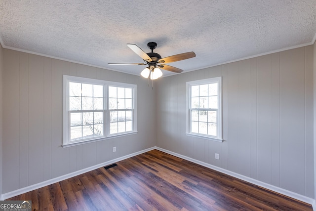 unfurnished room featuring a textured ceiling, dark wood-type flooring, ornamental molding, and ceiling fan