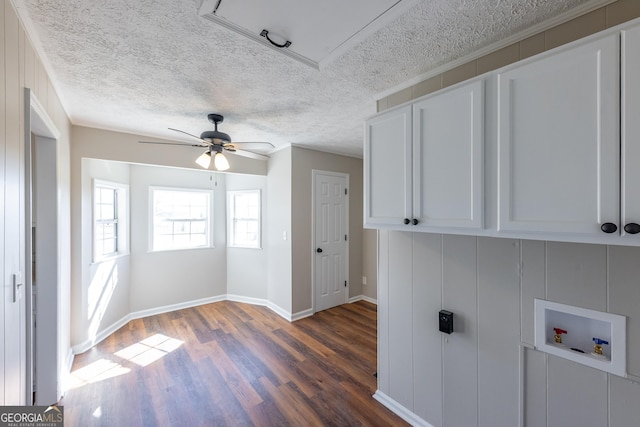 interior space with cabinets, a textured ceiling, dark hardwood / wood-style floors, ceiling fan, and washer hookup