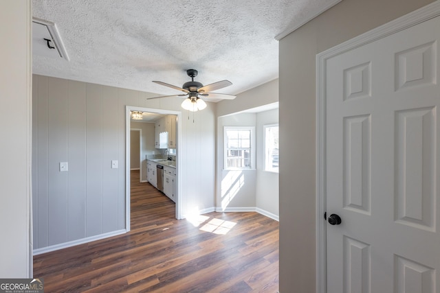 interior space with dark hardwood / wood-style flooring, a textured ceiling, and ceiling fan