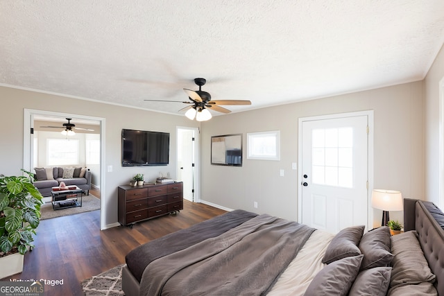 bedroom featuring ceiling fan, dark wood-type flooring, and a textured ceiling