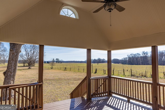 wooden deck featuring a rural view and ceiling fan