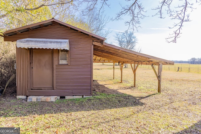 view of outdoor structure featuring a yard and a rural view