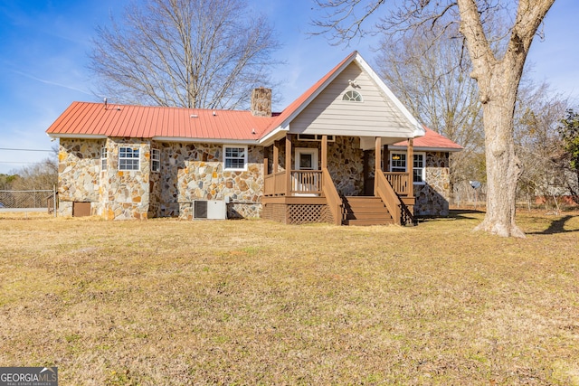 243 College St, Yatesville, GA 31097 - back of property featuring stone siding, central AC unit, a chimney, metal roof, and stairway