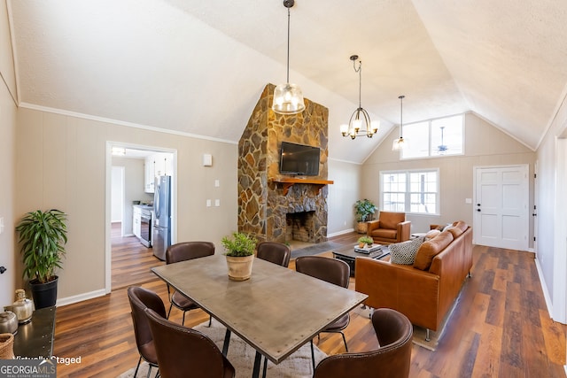 dining room with lofted ceiling, a fireplace, and dark hardwood / wood-style floors