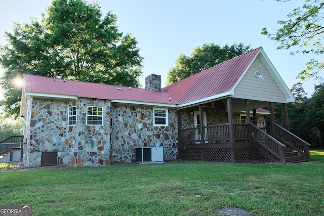243 College St, Yatesville, GA 31097 - back of house featuring stone siding, a chimney, and a lawn