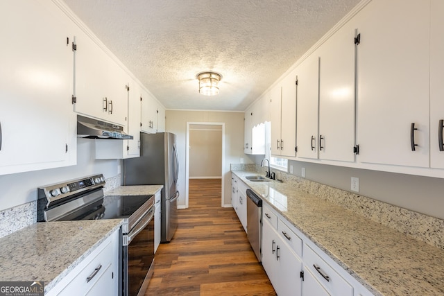 kitchen featuring appliances with stainless steel finishes, light stone countertops, sink, and white cabinets