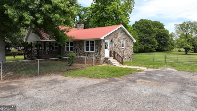 243 College St, Yatesville, GA 31097 - single story home with stone siding, a chimney, a gate, and metal roof