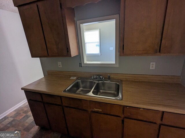 kitchen featuring sink and a textured ceiling