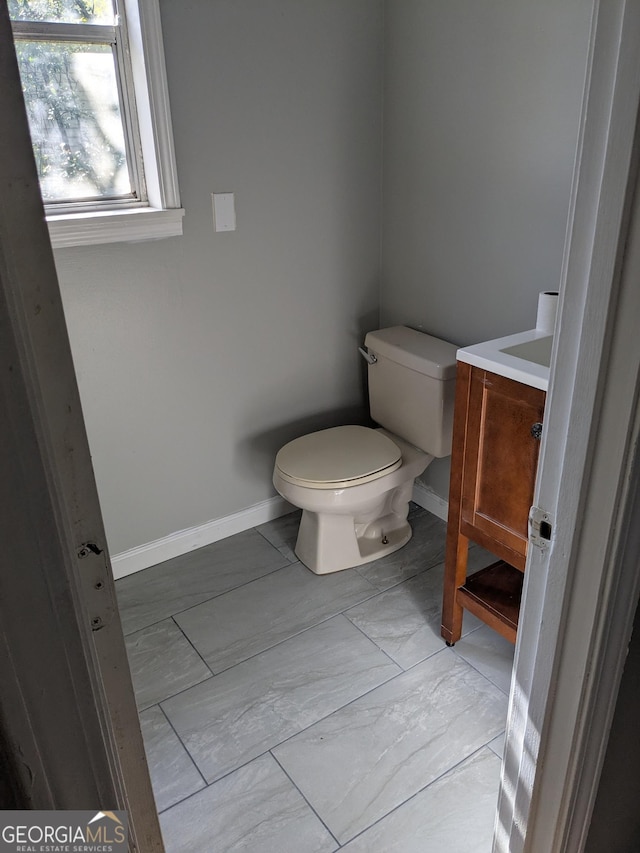 bathroom featuring vanity and toilet