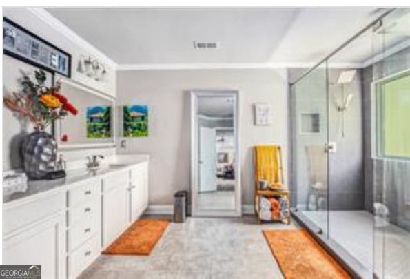 bathroom with vanity and an enclosed shower