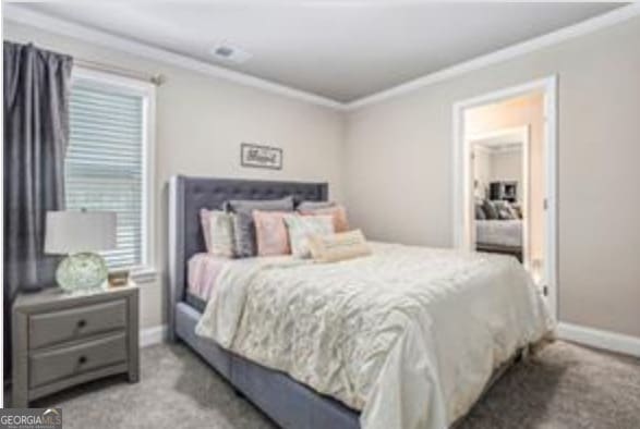 bedroom with crown molding and carpet flooring