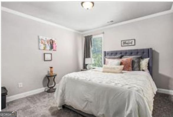 bedroom featuring crown molding and carpet