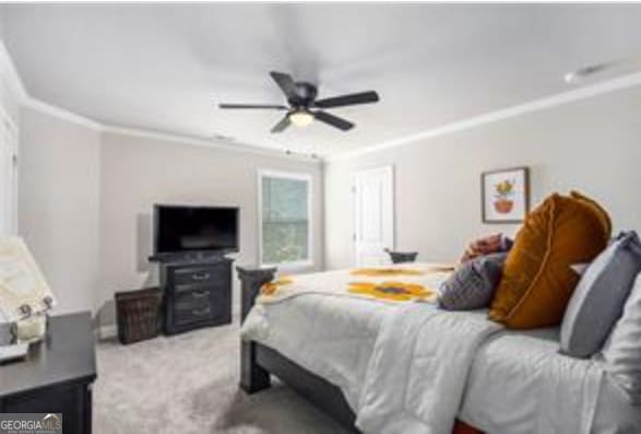 bedroom featuring crown molding, light colored carpet, and ceiling fan