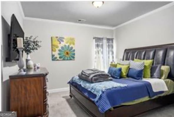 bedroom with crown molding and light colored carpet