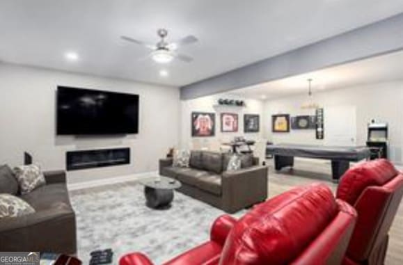 living room featuring ceiling fan and pool table