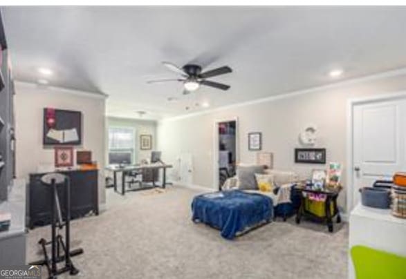 bedroom featuring ornamental molding, ceiling fan, and carpet