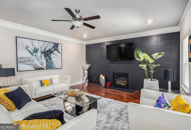 living room with hardwood / wood-style floors, a wealth of natural light, a fireplace, and ceiling fan