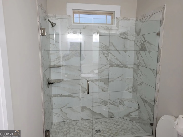 bathroom with a shower with door and toilet