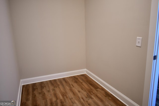 unfurnished room featuring hardwood / wood-style flooring