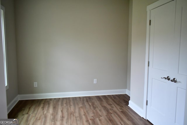 unfurnished bedroom with wood-type flooring