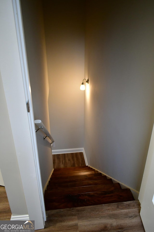 stairs with wood-type flooring