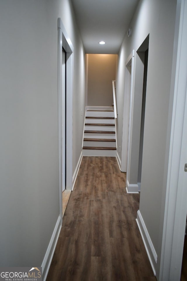 hallway with dark hardwood / wood-style floors